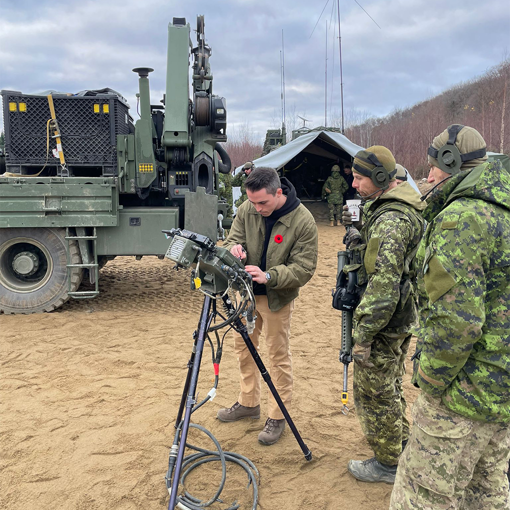 Canadian Armed Forces members setting up and operating equipment in a field environment.